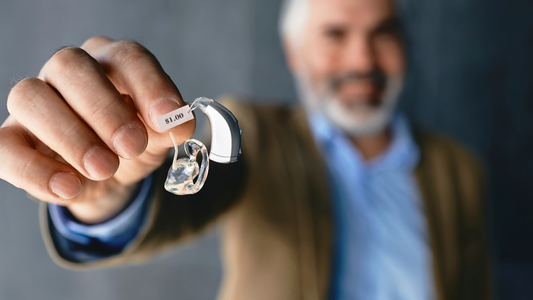 A close-up of a hearing aid with a price tag attached, representing the high cost of hearing aids.