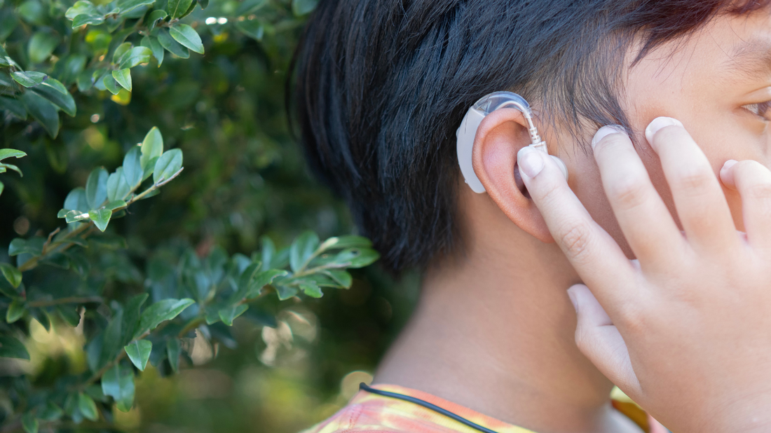 Illustration showing a person with an in-ear hearing aid, discreetly placed inside the ear canal.