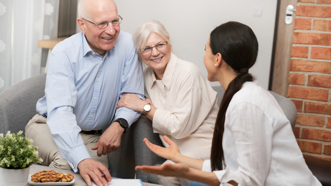 Elderly couple listening intently to their grandchild.