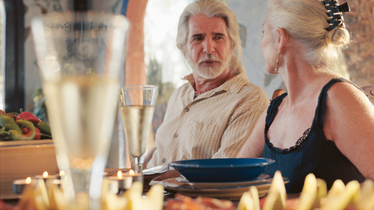 Elderly couple engaged in conversation.