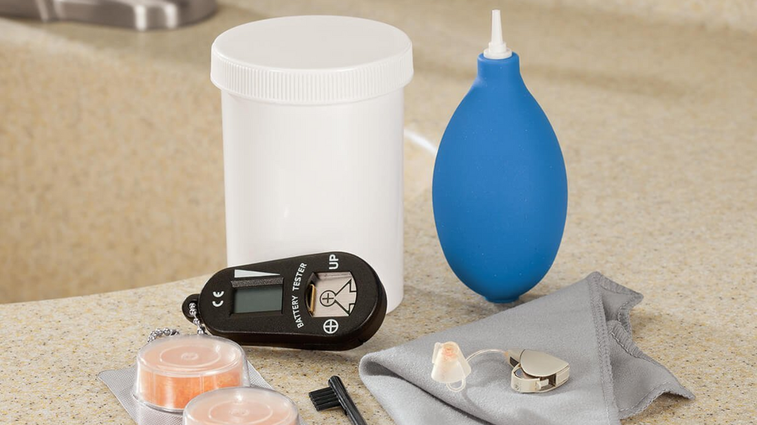 A selection of hearing aid accessories including drying containers, waterproof cases, and extra tips and tubes.