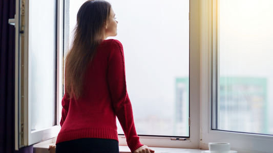 By the window, highlighting the potential hazards of hearing loss.