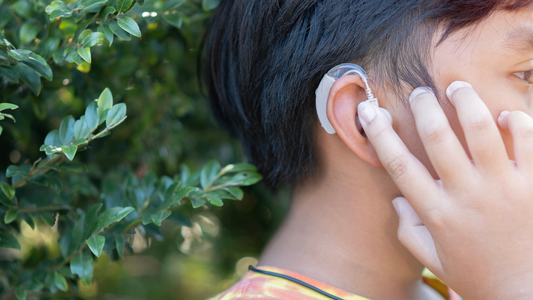 Illustration showing a person with an in-ear hearing aid, discreetly placed inside the ear canal.