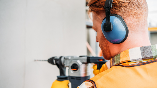 man wearing ear protection while working in a construction site.