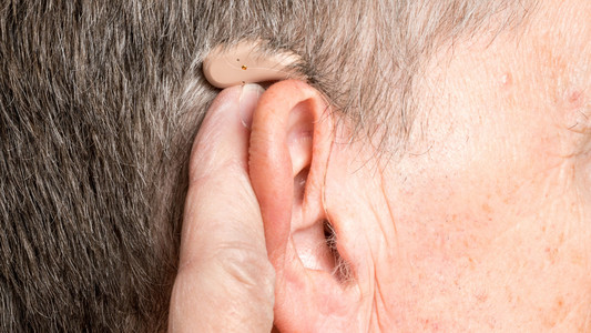 Close-up of a modern, discreet hearing aid.