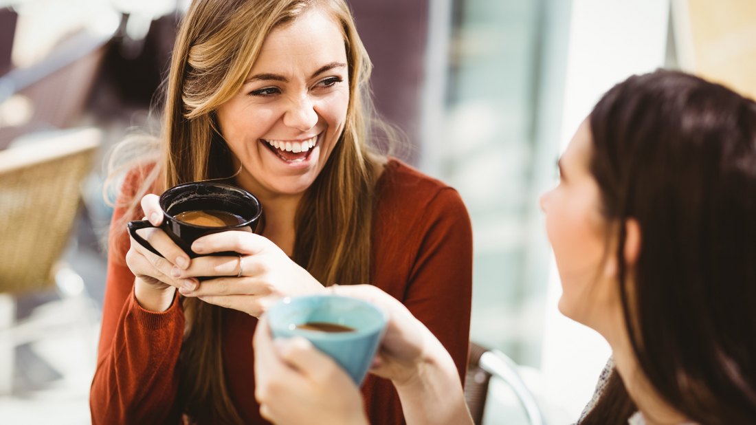 Friends chatting over coffee, symbolizing the importance of social connection for independence.