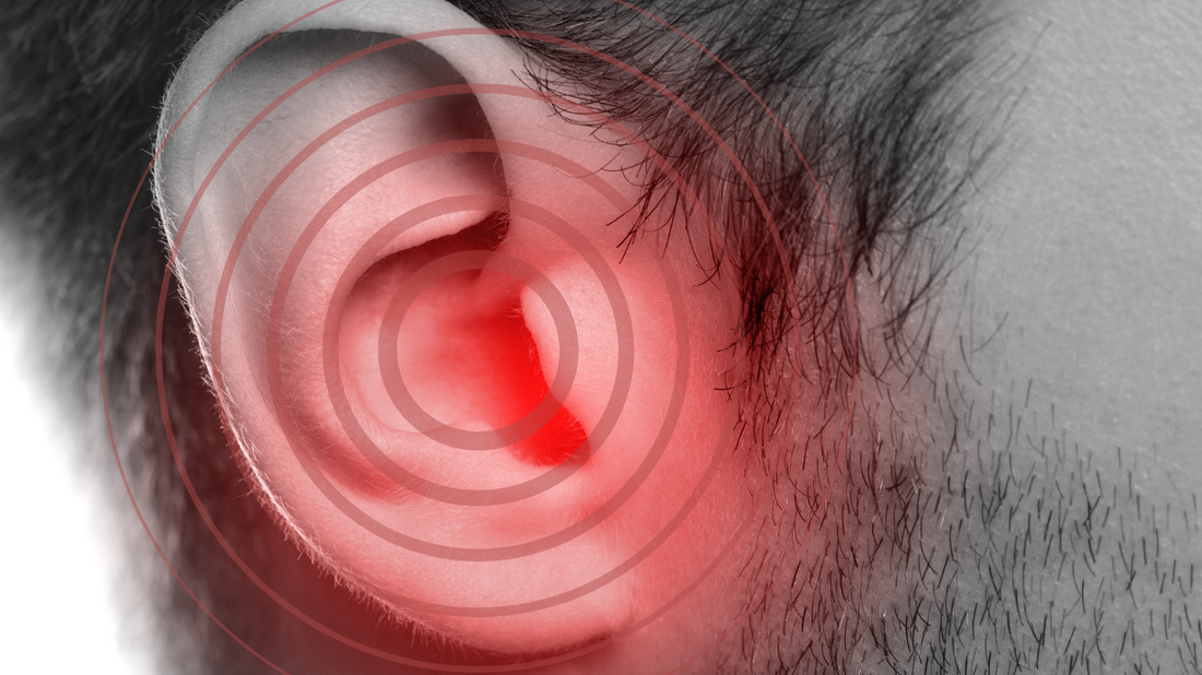 An illustration of an ear with sound waves representing tinnitus.