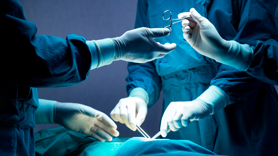 Surgeon performing surgery in an operating room.